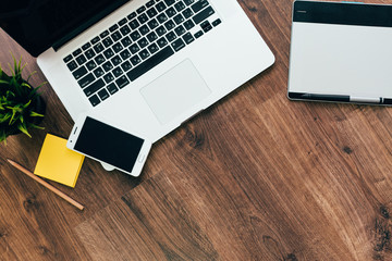 on a wooden table is a laptop