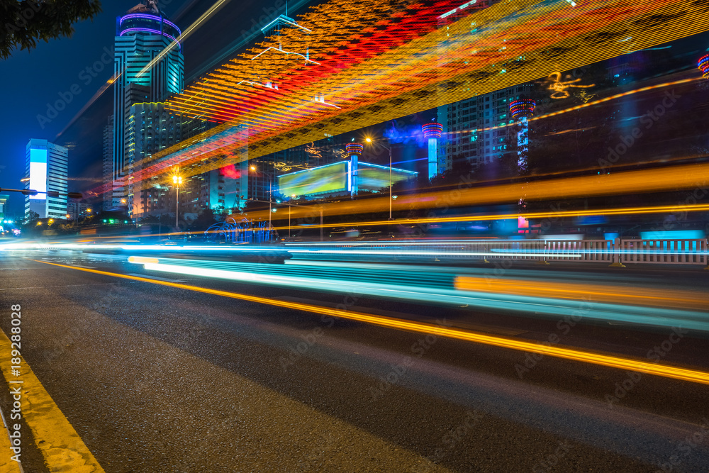 Wall mural the light trails on the modern building background.