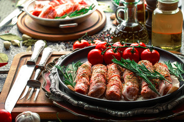 Raw meat on the kitchen table on a metallic background in a composition with cooking accessories