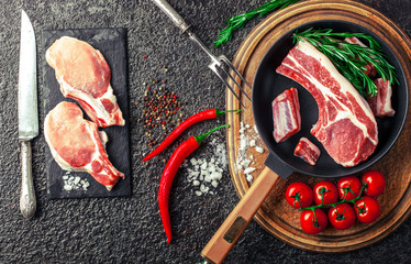 Raw meat on the kitchen table on a metallic background in a composition with cooking accessories
