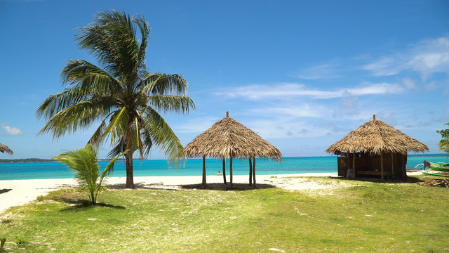 Beach with white sand with beach house on a tropical island Daco. Beautiful sky, sea, resort. Seascape: Ocean and beautiful beach paradise. Philippines. Travel concept.