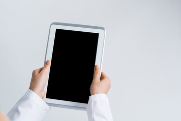 Close of female doctor hands working with tablet pc computer