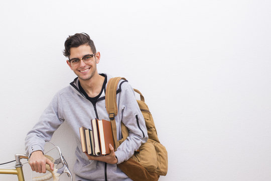 Fashion Student With Books And Bike On The Wall