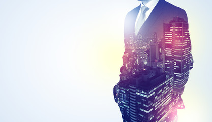 Businessman standing with night city graphic
