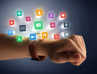 Female hand wearing smartwatch with app icons