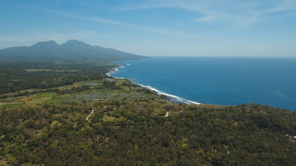 Aerial view sea coast, ocean, mountains, sea, beach, sky, clouds. Bali, Indonesia Seascape with Seashore on the background of mountains