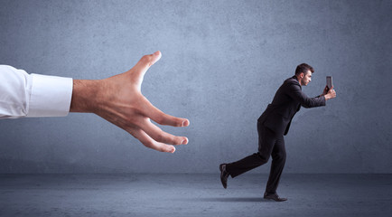 Businessman running from hand