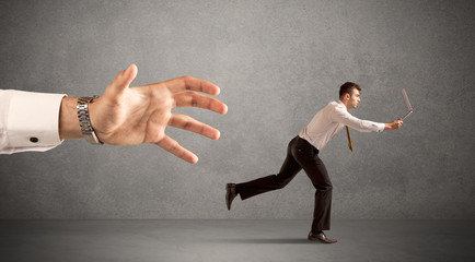 Businessman running from hand
