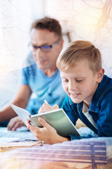 Make notes. Silhouette of delighted man that sitting on his bed and looking forward while being proud of his son