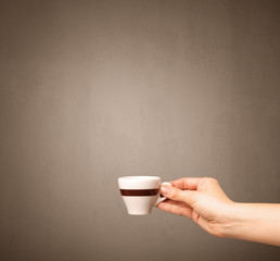 Female hand holding coffee cup
