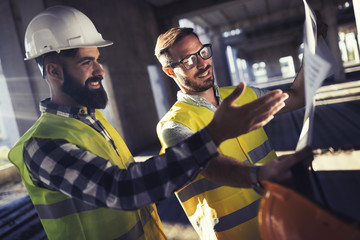 Portrait of construction engineers working on building site