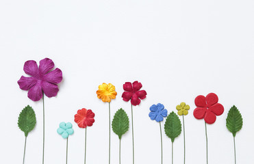 Obraz premium Colorful flower paper design with green leaf on white paper texture background, handmade flower paper, flower card concept