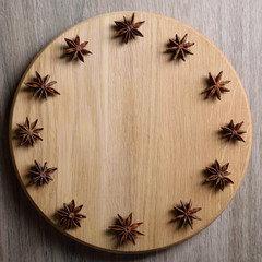  Concept wooden clock made of anise stars and shelves of cinnamon