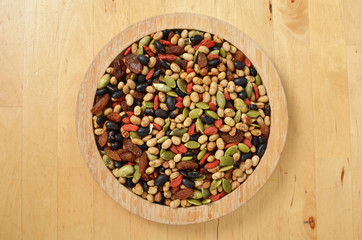 Colorful mix cereals, grain and seeds on wooden plate