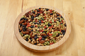 Colorful mix cereals, grain and seeds on wooden plate