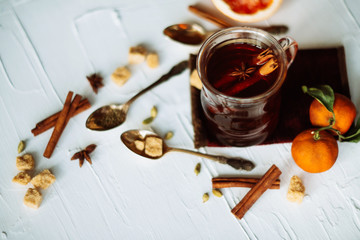 Cup of herbal tea on dark aged rustic background, top view, place for text, border