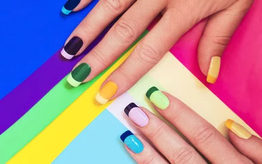 Fotobehang Manicure Veelkleurige pastel manicure gecombineerd toon op toon met een gestreepte achtergrond.Nail art.