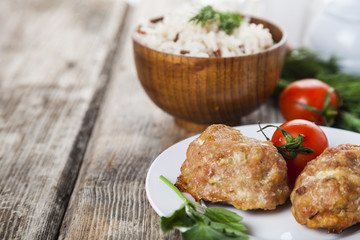 Delicious cutlets, rice, tomatoes and parsley
