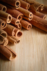  shelves of cinnamon and anise stars in dark backgrounds on a wooden background
