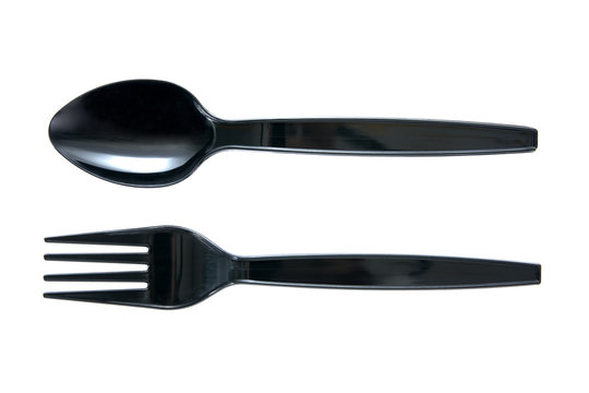 Plastic spoon and fork in black color isolated on white background