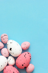 Fototapeta na wymiar Colorful quail eggs on a blue background. Easter background.