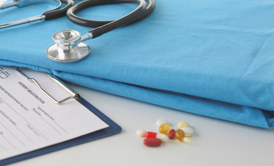 Stethoscope on a table with medical uniform