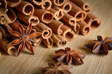  shelves of cinnamon and anise stars in dark backgrounds on a wooden background