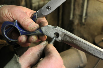 Man recompose a scissors after sharpening and brushing