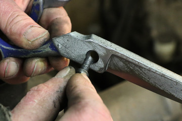 Man recompose a scissors after sharpening and brushing