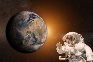 Astronaut in outer space on background of the Earth. Elements of this image furnished by NASA.