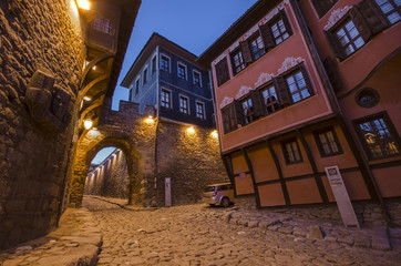 Night photo of houses and street under ancient fortress entrance of old town of city of Plovdiv, Bulgaria - European capital of culture 2019