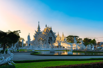Wat Rong Khun(White temple)at sunset in Chiang Rai,Thailand.23/01/2018 Wat Rong Khun is modern building, well known worldwide.It was designed by Chalermchai Kositpipat.Opened it to visitors in 1997.