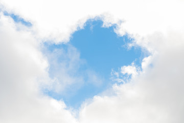 Scene bottom view of blue sky with white clouds shape half heart