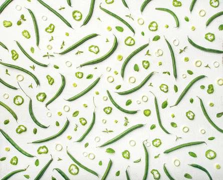 Food pattern, texture and background. Flat-lay of fresh green beans over white wooden background, top view. Healthy cooking, clean eating, vegan, weight loss, vegetarian, dieting concept