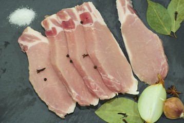 cut meat and spices on a cutting board. Steak, bacon, beef