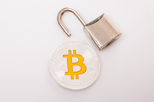 Silver bitcoin with a open lock isolated on white background