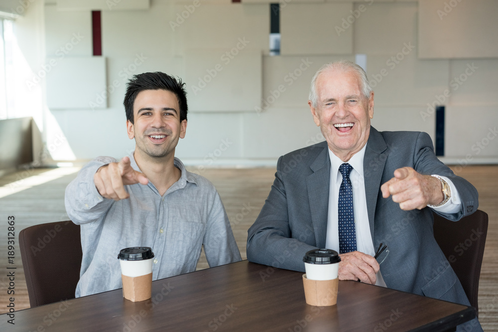 Wall mural Cheerful excited managers pointing at you