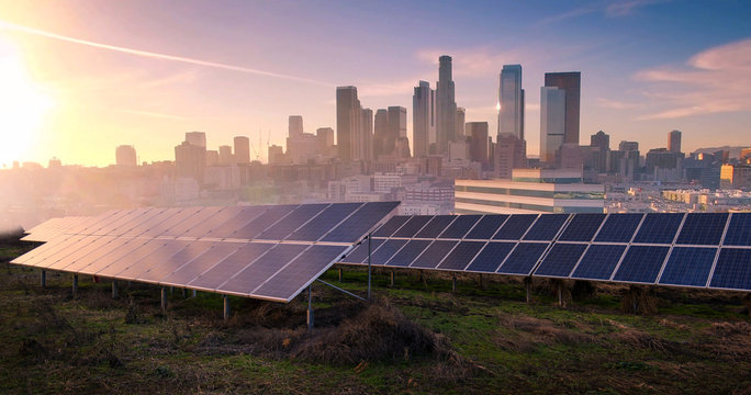 photovoltaic panels on sunrise front of the big city
