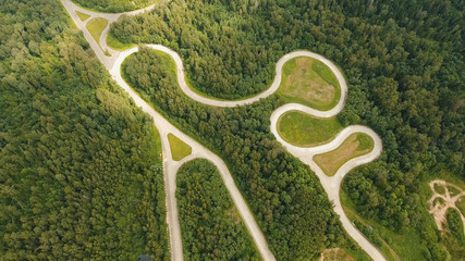 Aerial view Simulation of the mountain road for vehicle testing.Test road in the forest for testing and fine-tuning cars.