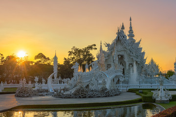Wat Rong Khun(White temple)at sunset in Chiang Rai,Thailand.23/01/2018 Wat Rong Khun is modern building, well known worldwide.It was designed by Chalermchai Kositpipat.Opened it to visitors in 1997.
