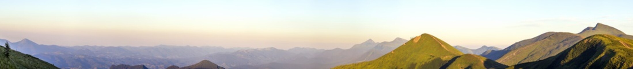 Carpathian mountain landscape in summer. Panoramic view. Sunset in Ukraine mountains. Wide panorama.