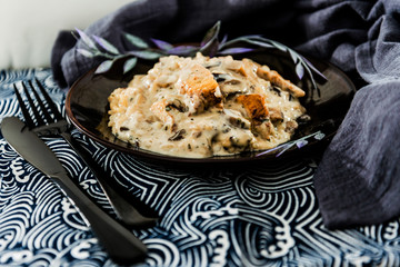 Tasty risotto with chicken, fresh herbs vegetables on a white plate