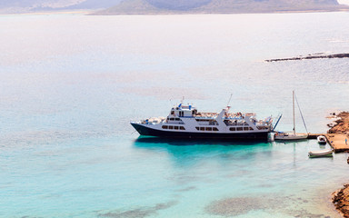 Fototapeta premium The yacht is moored at the shore of the island