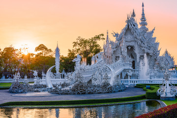 Wat Rong Khun(White temple)at sunset in Chiang Rai,Thailand.23/01/2018 Wat Rong Khun is modern building, well known worldwide.It was designed by Chalermchai Kositpipat.Opened it to visitors in 1997.
