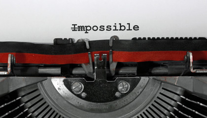 WORD IMPOSSIBLE with the text IM deleted and then everything is possible written with the typewriter