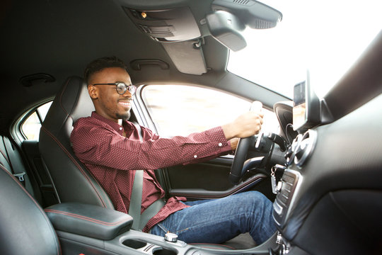 happy young black guy driving car