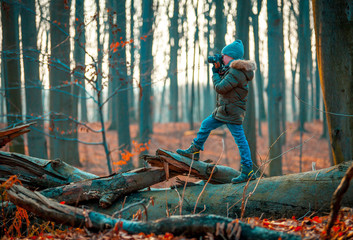Boy using digital camera taking photo in the nature, hobby concept