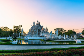 Wat Rong Khun(White temple)at sunset in Chiang Rai,Thailand.23/01/2018 Wat Rong Khun is modern building, well known worldwide.It was designed by Chalermchai Kositpipat.Opened it to visitors in 1997.
