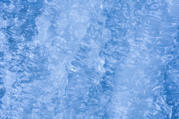 Obraz na płótnie Canvas Background of Blue ice with a wavy structure