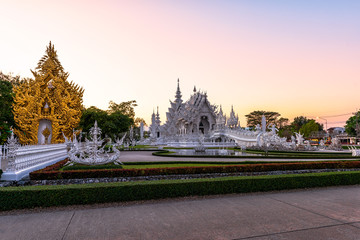 Wat Rong Khun(White temple)at sunset in Chiang Rai,Thailand.23/01/2018 Wat Rong Khun is modern building, well known worldwide.It was designed by Chalermchai Kositpipat.Opened it to visitors in 1997.